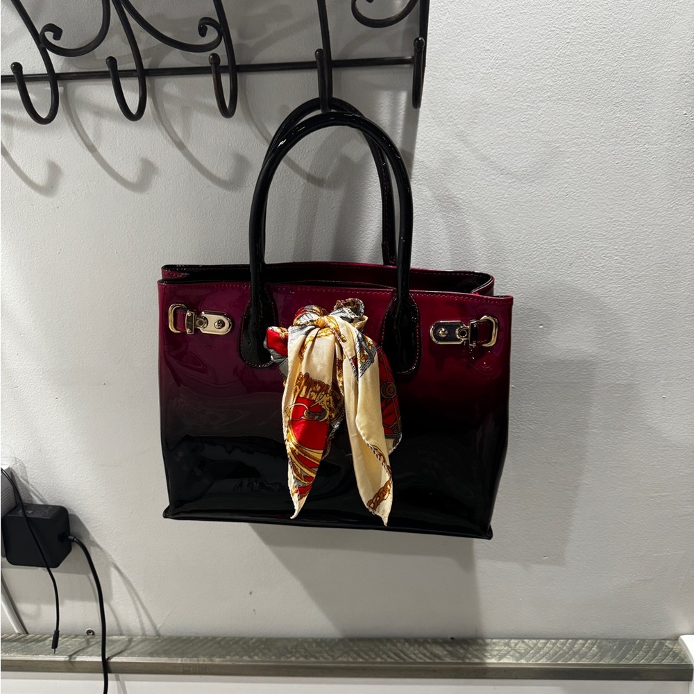 Patent leather. Red/burgandy. Hand held